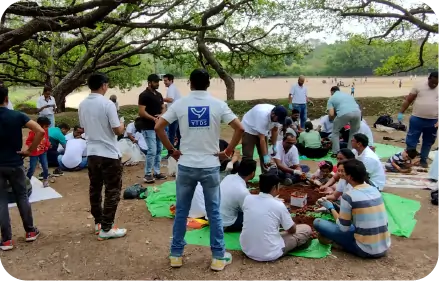 Volunteers preparing seedballs in group activity  